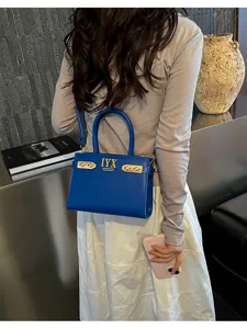 Stylish blue women shoulder handbag featuring metal buckle and elegant letter details.