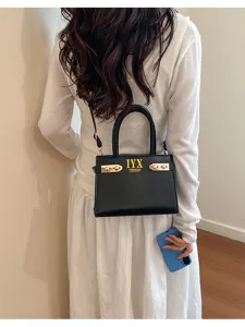 Fashionable black shoulder bag with gold hardware, elegant design for women daily wear.