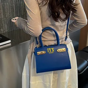 Stylish blue leather shoulder bag for women, elegant top handle tote purse with chic metal hardware.