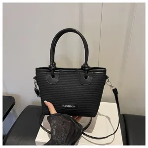 Detailed view of the black woven bucket bag showing its unique rope knot handles.