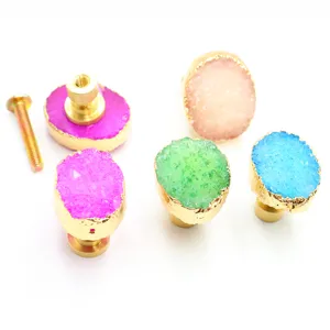Close-up detail of colorful natural stone crystal cabinet knobs with elegant gold brass base.