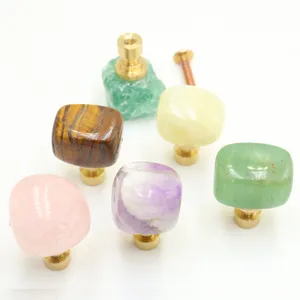 Natural crystal stone cabinet knob with brass base, detail view of drawer pull hardware.