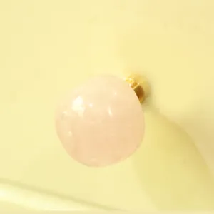 Natural rose quartz crystal drawer knob detail view, luxury brass single hole cabinet handle