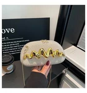 Elegante Damen Umhängetasche mit glitzerndem Stoff und auffälligem goldenem Wellenmetall-Detail.