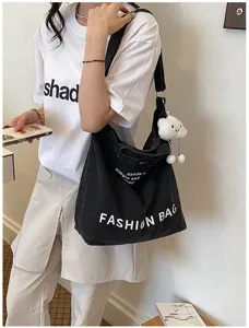 Black denim shoulder bag with casual fashion design and large capacity for daily use.