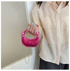 Pink glitter detail and circle handle of the stylish mini crossbody bag for women closeup.