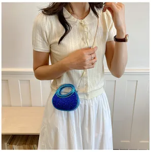 Stylish women's mini crescent crossbody bag with acrylic handle and sparkly sequin design.