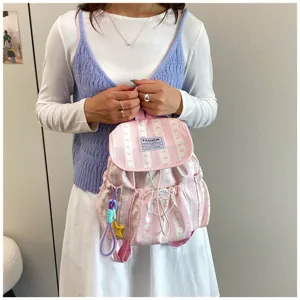 Pink striped fashion student backpack with bow pattern, large capacity daily school bag detail.