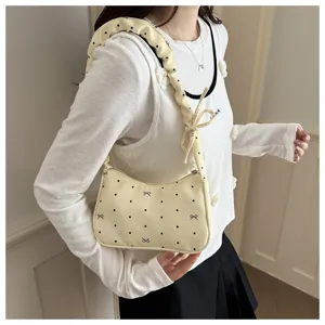 Stylish sweet pleated crescent shoulder bag for women, cute polka dot design with bow.