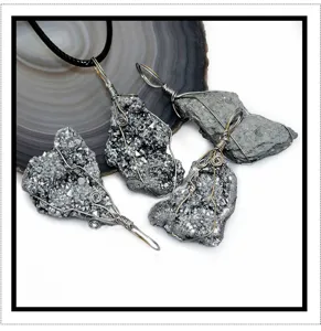 Detailed view of natural raw druzy crystal cluster wire wrapped pendants with black cord.