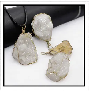 Close-up of raw crystal druzy pendant with handmade wire wrapping and black cord necklace details.