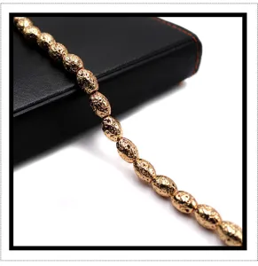 Gold-plated textured lava stone barrel beads strand detail, perfect for DIY jewelry making.
