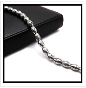 Electroplated silver lava stone beads close-up, textured barrel beads for DIY handmade jewelry.