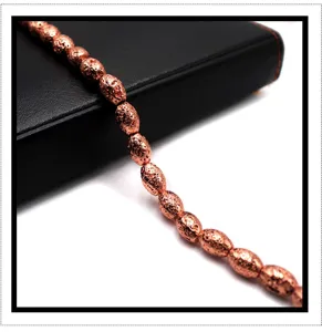 Close-up view of copper plated volcanic stone barrel beads detail, ideal for jewelry making.
