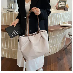 Casual minimalist commuting nylon tote bag for women, stylish lightweight shoulder underarm bag.