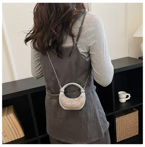 Trendy shiny underarm bag detail showcasing the metallic ring and sequin crossbody design.
