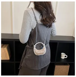Chic sparkly evening shoulder bag detail, stylish metal ring handle design for women daily wear.