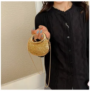 Elegant mini glitter evening bag with metal ring handle and chain strap, shiny detail view.