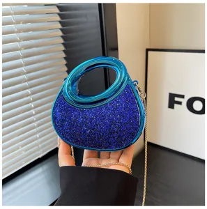 Detail view of stylish acrylic handle crescent evening bag with glittering blue sequins.