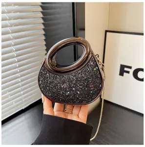 Detailed view of the stylish acrylic crescent evening bag with glittering sequins and sleek chain strap.