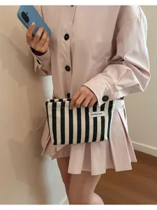 Pochette à rayures noires et blanches pour femmes, sac de maquillage tendance contrasté de soirée.