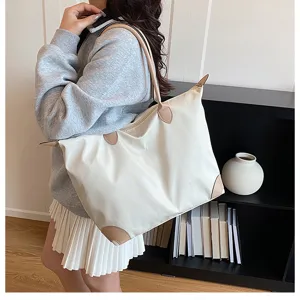 Large capacity travel tote bag for women, stylish oversized shoulder luggage handbag.