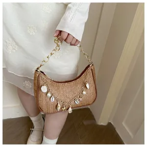 Woven straw underarm bag with shell pendant, stylish chain shoulder handbag for women.
