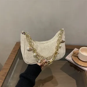 Stylish woven straw shoulder bag for women, trendy beach underarm handbag with chic chain.