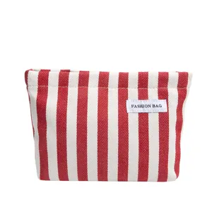 Trousse de maquillage en toile à rayures rouges et blanches, pochette élégante usage quotidien.