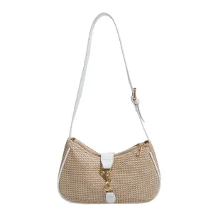 Trendy straw woven shoulder bag for women, chic white leather trim and golden metal clasp.