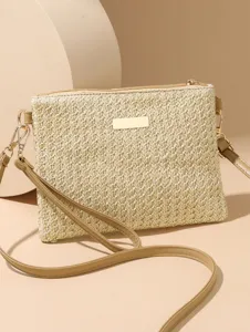 Detailed view of the straw woven shoulder bag, featuring textured crochet and gold hardware.