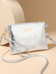 Silver metallic crossbody bag detail, featuring sleek finish and gold-tone hardware accent.