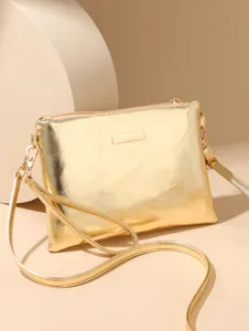 Close-up detail of the shiny metallic gold crossbody shoulder bag with zipper and strap.