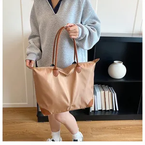 Large capacity travel bag, nylon weekender luggage with brown leather trim for women.