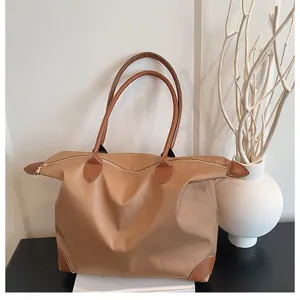 Large capacity travel tote bag for women, lightweight nylon weekender bag with chic leather trim.