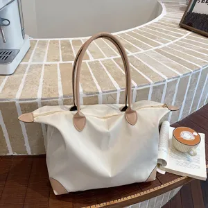 Large capacity travel tote bag, oversized luggage shoulder bag for women short trips.