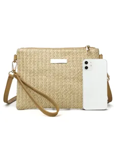 Detail shot showcasing the straw woven texture and metal clasp of this stylish summer beach bag.