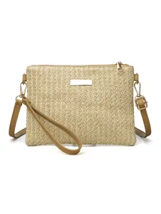 Close-up detail of the woven straw crossbody bag showcasing the delicate texture and hardware.