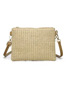 Detailed view of casual straw woven crossbody bag with leather straps and gold hardware.