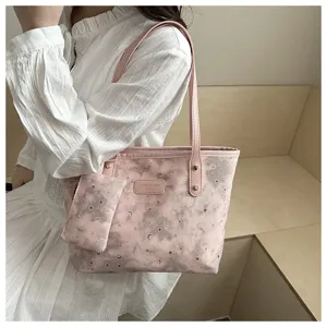 Detail view of the pink star moon tote bag with a small pouch, closeup on shoulder carry.