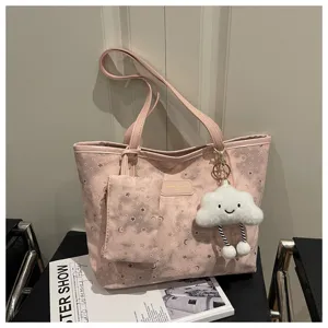 Pink tote bag detail showing star moon pattern, small pouch, and cute cloud keychain pendant.
