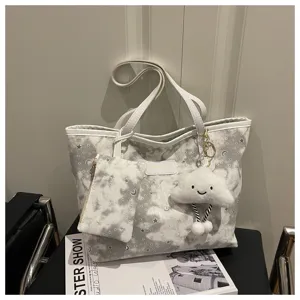 Trendy large capacity star moon print shoulder bag with small pouch and cute cloud plush.