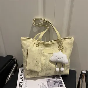 Trendy minimalist large capacity shoulder bag with star moon pattern and cute cloud keychain.