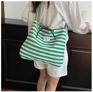 Casual striped canvas tote bag detail view, green and white shoulder bag for daily commuting.
