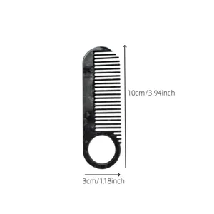 Black acetate hair comb with marble pattern and round hole design, compact styling.