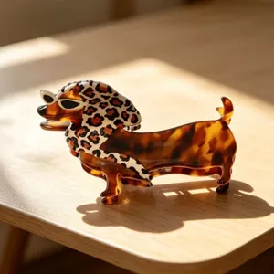 Cute tortoiseshell dachshund hair claw acetate shark clip close up product detail view.