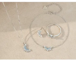 Close-up detail of S925 sterling silver moon and sun pendant necklace bracelet ring set.
