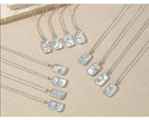 Close-up detail view of the elegant rectangular mother-of-pearl constellation necklace pendant.