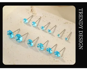 Close-up view of sparkling blue zircon silver stud earrings set, exquisite jewelry detail.
