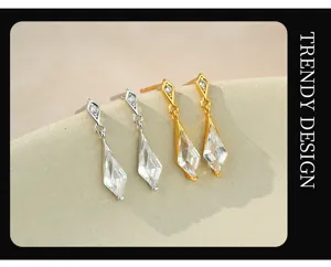 Close-up detail of elegant kite-shaped drop earrings featuring sparkling clear crystals.